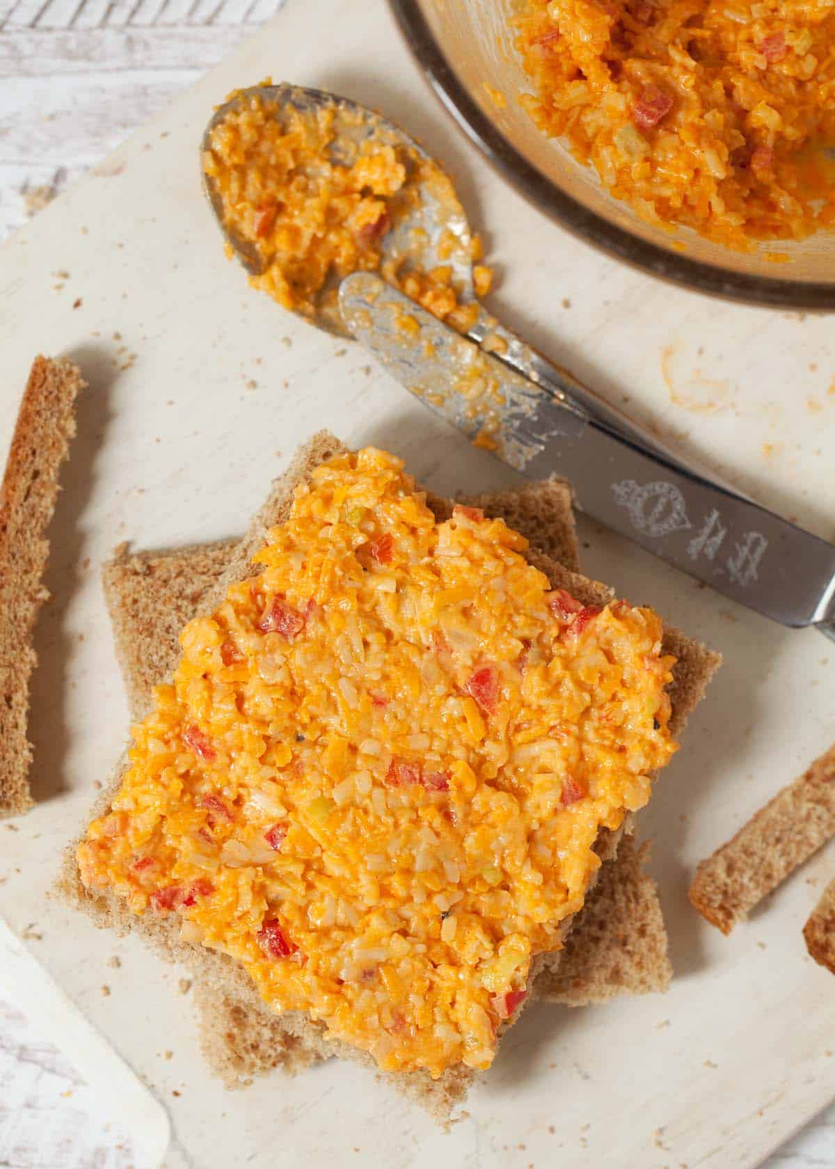 making sandwiches for afternoon tea: step three - spread out the cheese savoury sandwich filling